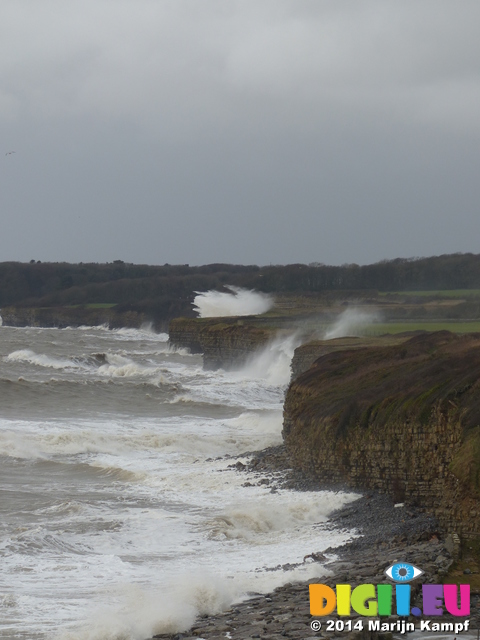 LZ00680 Waves crashing against cliffs at Llantwit Major beach